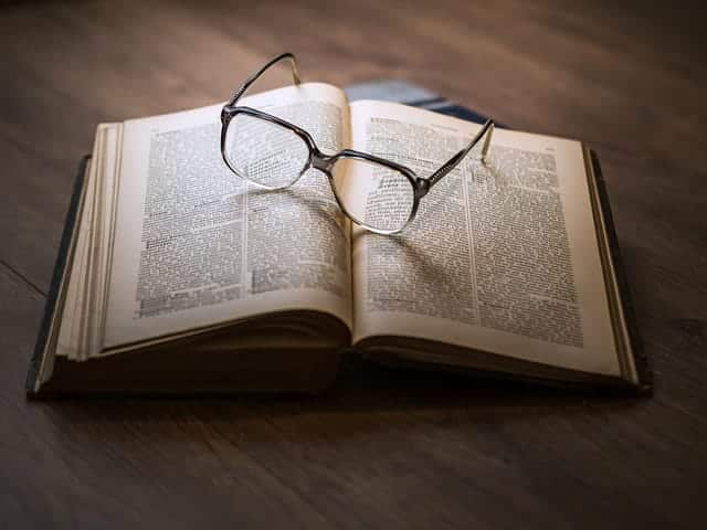 Open bible with reading glasses on top