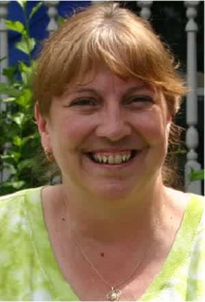 image of Tess, a woman with brown hair smiling